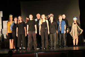 Menschen stehen auf einer Bühne.