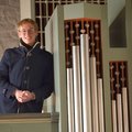 Ein junger Mann lehnt sich an eine Orgel